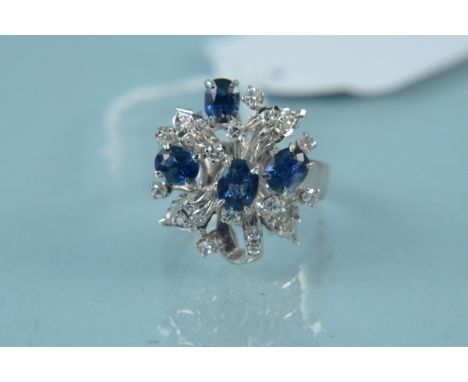 An unmarked white metal sapphire and diamond cluster ring, size M, weight approx 6g