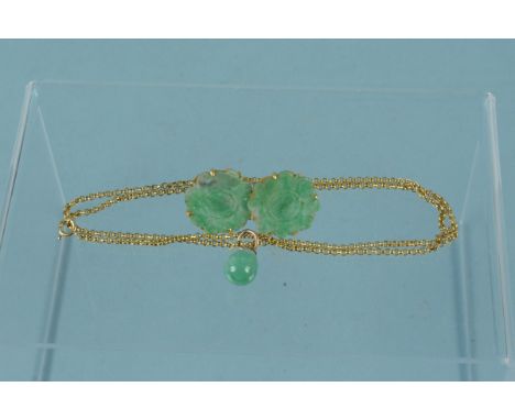 A jade pendant mounted in yellow metal on a 9ct gold chain plus a pair of large carved jade yellow metal mounted floral style