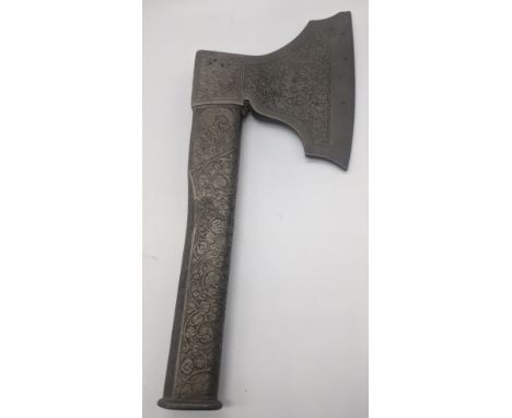 An Eastern axe, cast metal with scrolling decoration, L.31cm