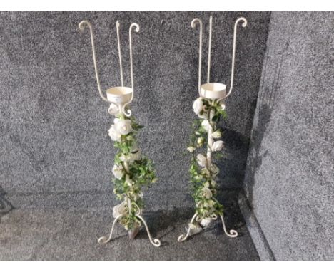 A pair of white painted metal torchieres with light up bridal flowers to supports 100cm high.