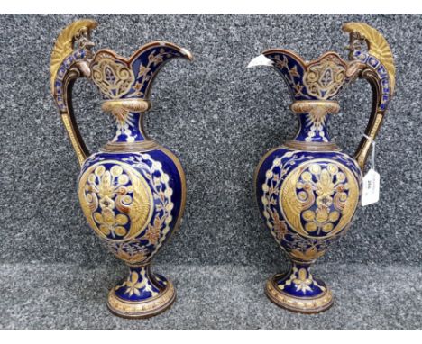 A pair of late 19th century German etruscan style ceramic ewers (damage) marks to base 36cm high.