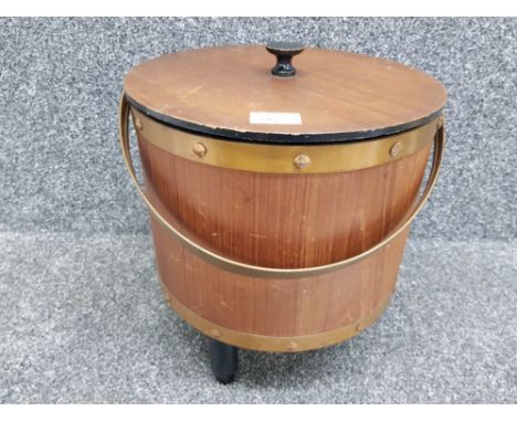 A vintage circular teak work box with contents 34cm high.