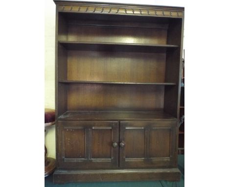 An Oak Three Shelf Bookcase with Cupboard Base.