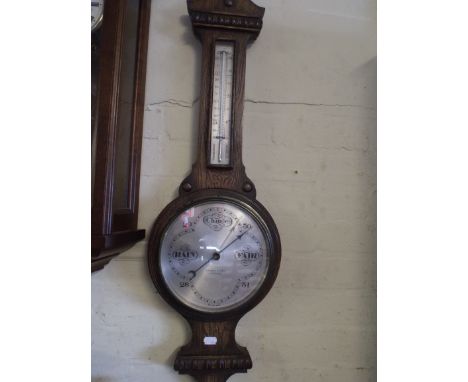 An Edwardian Oak Wheel Barometer by J Parkes and Sons Liverpool.