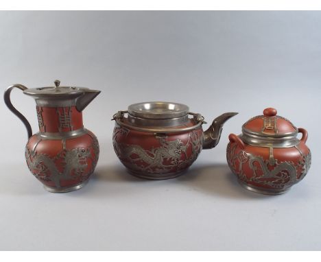 An Early 20th Century Oriental Three Piece Tea Service with Pierced Pewter Mounts The Base Signed Wen Hua Shun. 