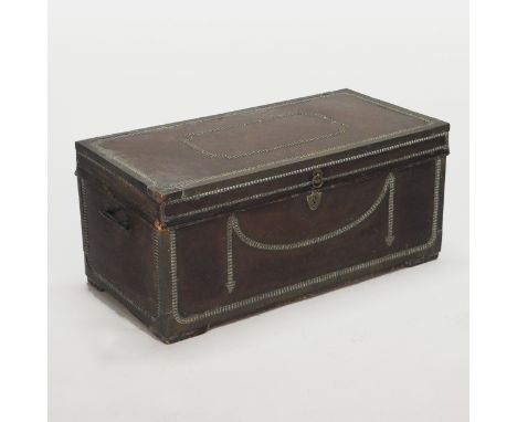 A Regency leather clad trunk, with a hinged lid and studded decoration, 92cm