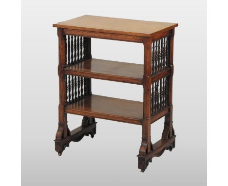 A Victorian Gothic revival light oak book table, having three tiers, united by turned spindles, 63cm