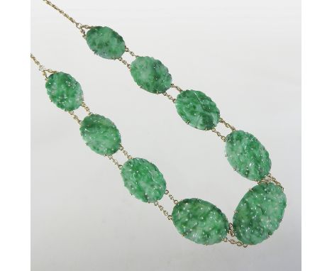 A Chinese 14 carat gold necklace, mounted with nine oval sections of carved jade 