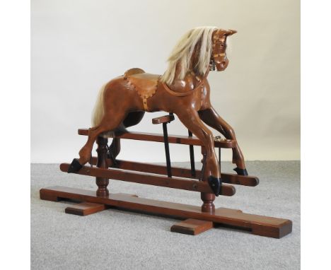 A brown painted wooden rocking horse, 165cm long overall