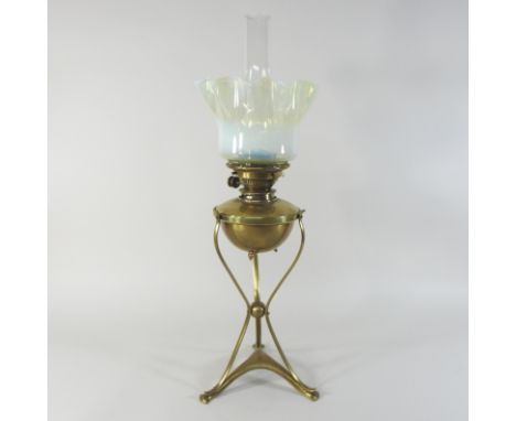 An Arts and Crafts brass oil lamp, by WAS Benson, three hammers mark to base, the reservoir with a Hinks patent, James Gray &