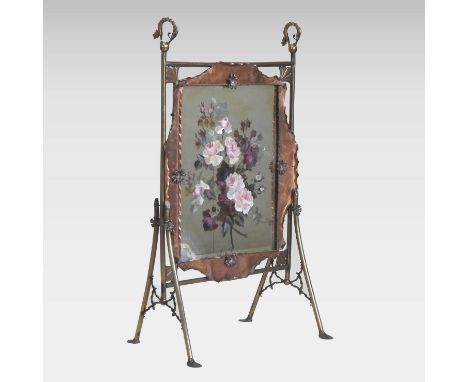 An Arts and Crafts brass and copper firescreen, the mirrored panel, painted with flowers, 55cm