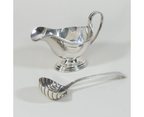 A modern silver sauce boat, of helmet shape, Sheffield 1969, 15cm long, together with a 19th century silver sauce ladle, with