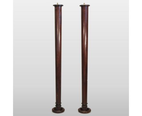 A pair of large turned mahogany architectural columns, each with a lappet carved capital, 212cm high