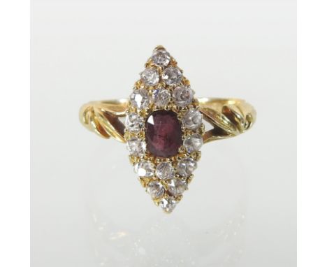 An 18 carat gold ruby and diamond cluster ring, of elliptical shape, with scrolled openwork shoulders