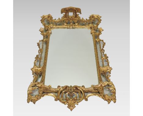 An ornate gilt framed wall mirror, in the Chinese Chippendale taste, with an ornate scrolled surround, surmounted by a pagoda