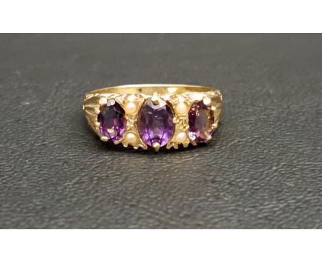 AMETHYST AND SEED PEARL RINGthe three graduated oval cut amethysts separated by seed pearls, the central amethyst approximate