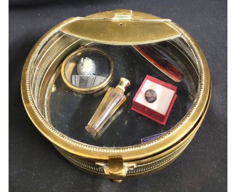 TRENCH ART STYLE DISPLAY CASEwith spring loaded lid, the brass rim with inserts, raised on ball feet with glass base and lid,