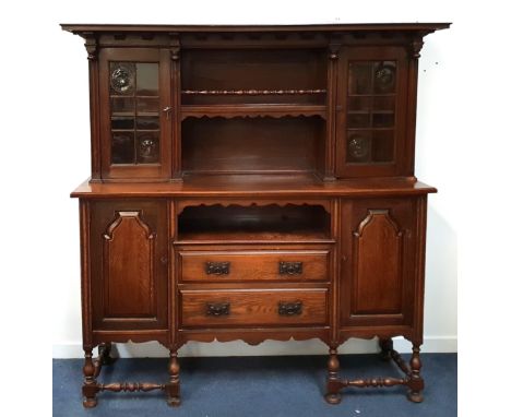LARGE OAK SIDEBOARD/DRESSERthe upper section with two glazed drawers flanking open shelves, above two outer cupboard doors an