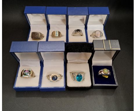 EIGHT VARIOUS GEM SET SILVER RINGSof various sizes and designs, including an opal and ruby ring, a mystic topaz dress ring wi