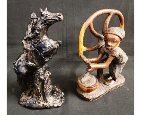 CARVED WOODEN FIGURE OF AFRICAN LADY the lady turning a wheel and collecting water, made of one piece of hardwood, 28cm high;