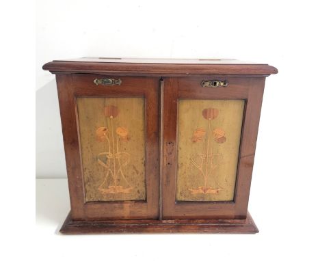 ART NOVEAU MAHOGANY SMOKERS CABINETthe front hinged doors with marquetry panels of stylised tulips on stained wood, revealing