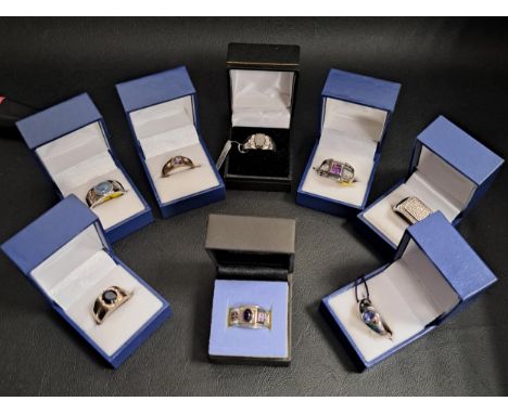 EIGHT VARIOUS GEM SET SILVER RINGSof various sizes and designs, including a diamond cluster ring, and others set with amethys