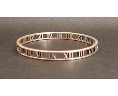 TIFFANY & CO. SILVER ATLAS OPEN BANGLEthe pierced bangle set with Roman numerals, 6.5cm diameter