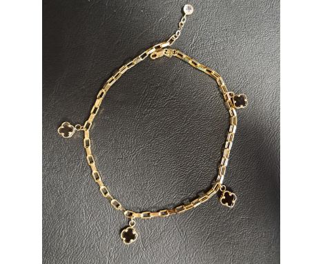 FOURTEEN CARAT GOLD BRACELETin the style of Van Cleef & Arpels, with four black enamel decorated quatrefoil charms, approxima