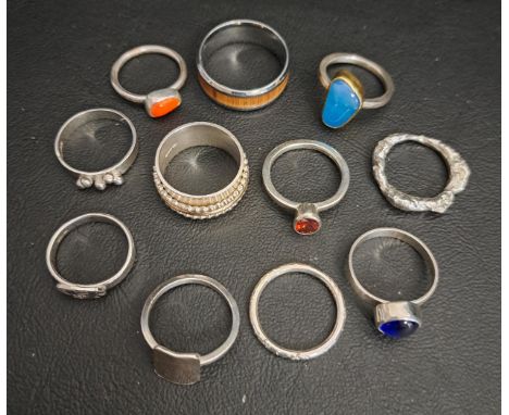 ELEVEN SILVER RINGSincluding a spinner ring and enamel and stone set examples (11)