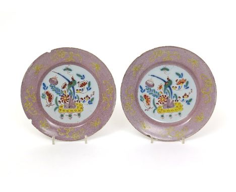A pair of Lambeth delftware plates  c.1750, the wells painted in polychrome enamels with a long-tailed bird perched on flower