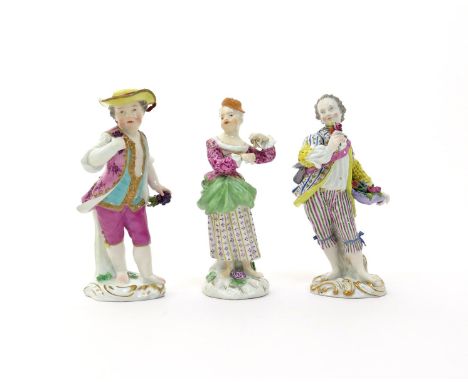 Three Continental porcelain figures of children  19th century, Meissen or Meissen-style, one of a girl playing the triangle, 