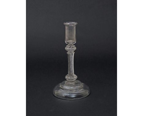A glass candlestick  c.1760, the cylindrical sconce raised on a composite stem of air beaded knops either side of an airtwist