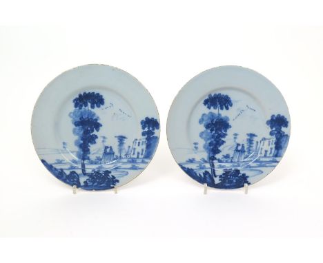A pair of Bristol delftware plates  c.1760, painted in the Bowen manner, each with two ladies beneath tall sponged trees in a