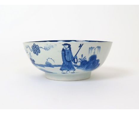 A Bow blue and white punch bowl  c.1760, painted with the Golfer and Caddy pattern, the two Chinese figures separated by a gn