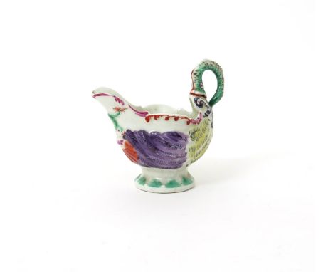 A Worcester dolphin ewer creamboat  c.1765-68, of traditional form, moulded beneath the spout with two dolphins with tails en