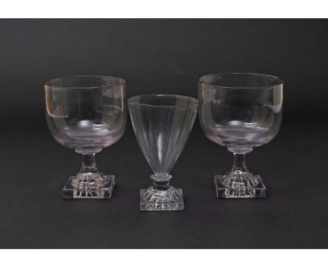 A pair of English rummers  c.1800, with large rounded funnel bowls raised on square lemon squeezer bases, and a third smaller