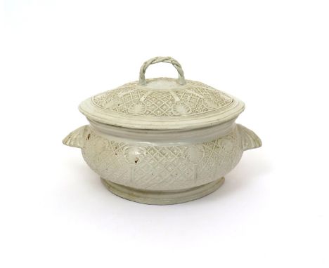 A salt-glazed stoneware tureen and cover  late 18th century, the oval body moulded with differing diaper panels between shell
