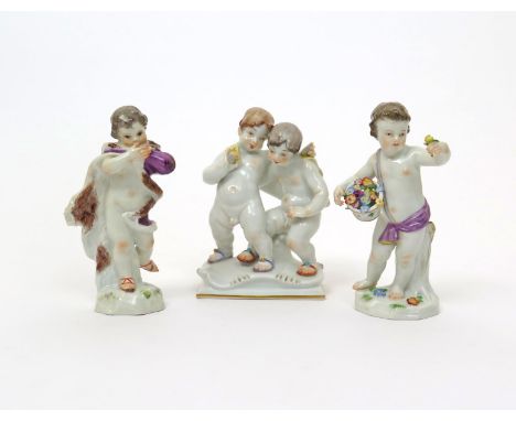 Three Meissen figures of putti  20th century, two emblematic of Spring and Winter with appropriate attributes of a basket of 