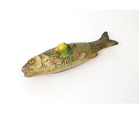 A Continental maiolica fish tureen and cover  late 19th century, modelled as a long fish with brown and black scales, a lemon
