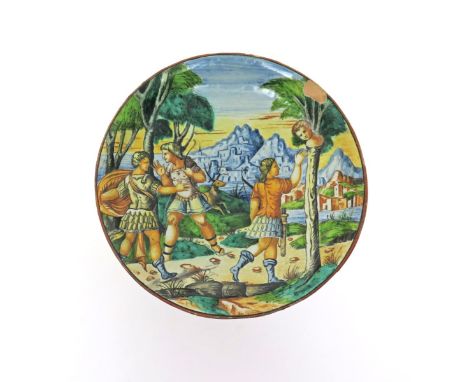 An Italian maiolica plate  probably 19th century, painted with three hunting figures with bows and arrows before buildings am