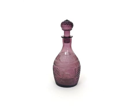 An amethyst glass decanter and stopper  c.1820, perhaps American, moulded with starburst designs and diamond banding, 27cm. (