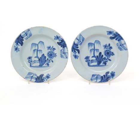 A pair of English delftware plates  mid 18th century, probably London, painted in blue with a weeping willow tree and large f