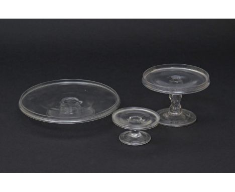 Two small glass tazzae and a patch stand  mid 18th century, one raised on a very low folded foot, the other on a triple knopp