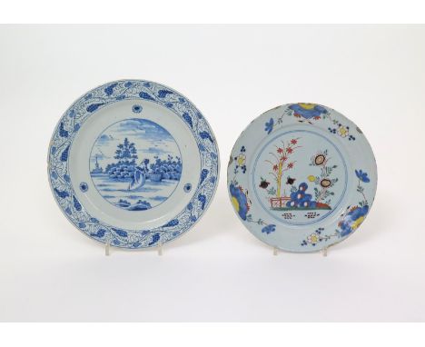 A polychrome delftware plate  18th century, brightly painted with bamboo and chrysanthemum beside holey rockwork, and a Delft