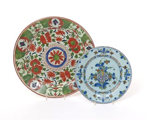 A large Dutch Delft charger  18th century, decorated in green and red with blue highlights, with a stylized floral design, an