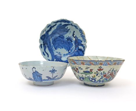Three delftware punchbowls  c.1730-80, one early with steep sides painted in blue, red and green with birds between flowering