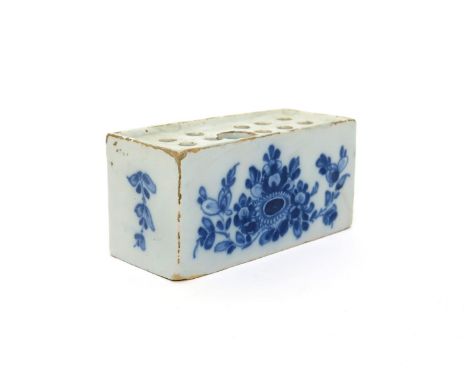A delftware flowerbrick  c.1750, probably Dublin, painted in blue with simple sprays of Oriental flowers, each narrow side wi