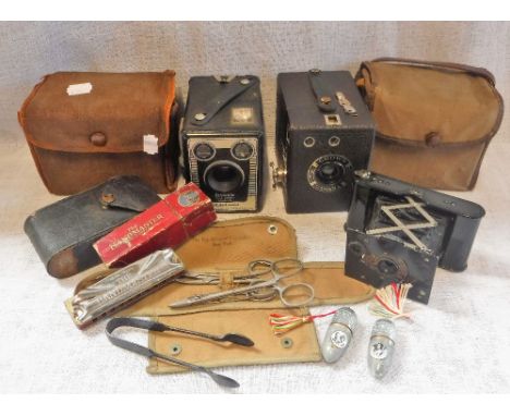 A KODAK BOX CAMERA in fitted case and other similar cameras