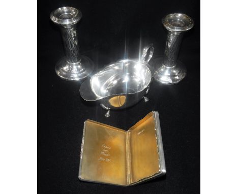 A SILVER CARD CASE with engine turned decoration and gold(?) clasp, Birmingham 1933, a silver sauce boat Birmingham 1935 and 
