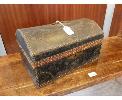 AN EARLY 19TH CENTURY LEATHER COVERED DOME-TOP TRUNK of small proportions, with brass stud work, the interior with original m